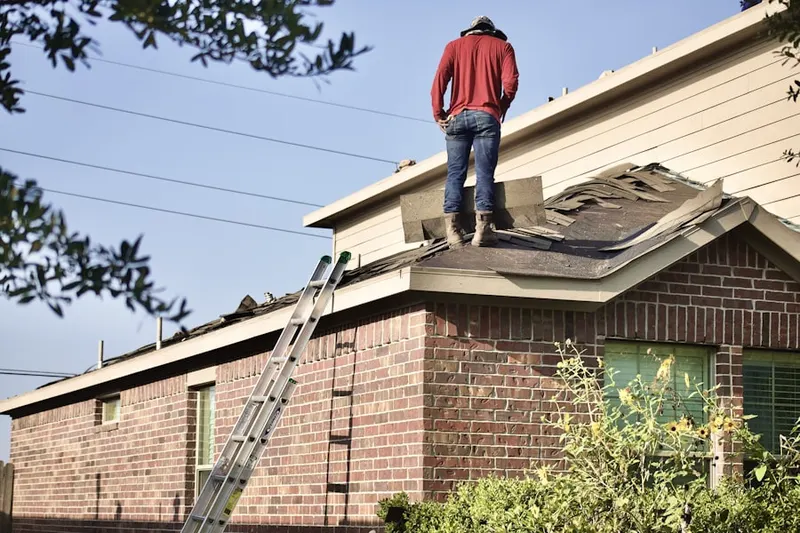 Professional roofer working on a residential roof in Downtown Mulberry